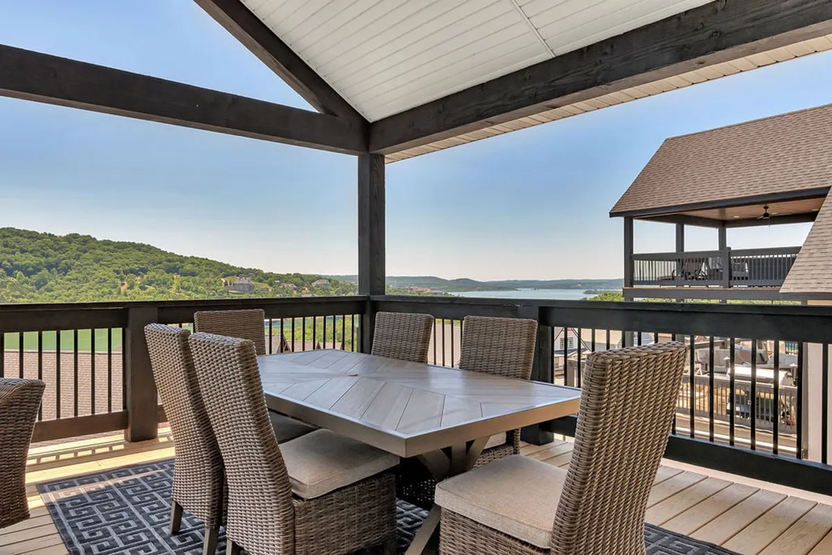 An inviting outdoor dining setup with a table and chairs positioned to enjoy a scenic hillside view. The scene suggests opportunities for group meals, morning coffees, or sunset celebrations together.